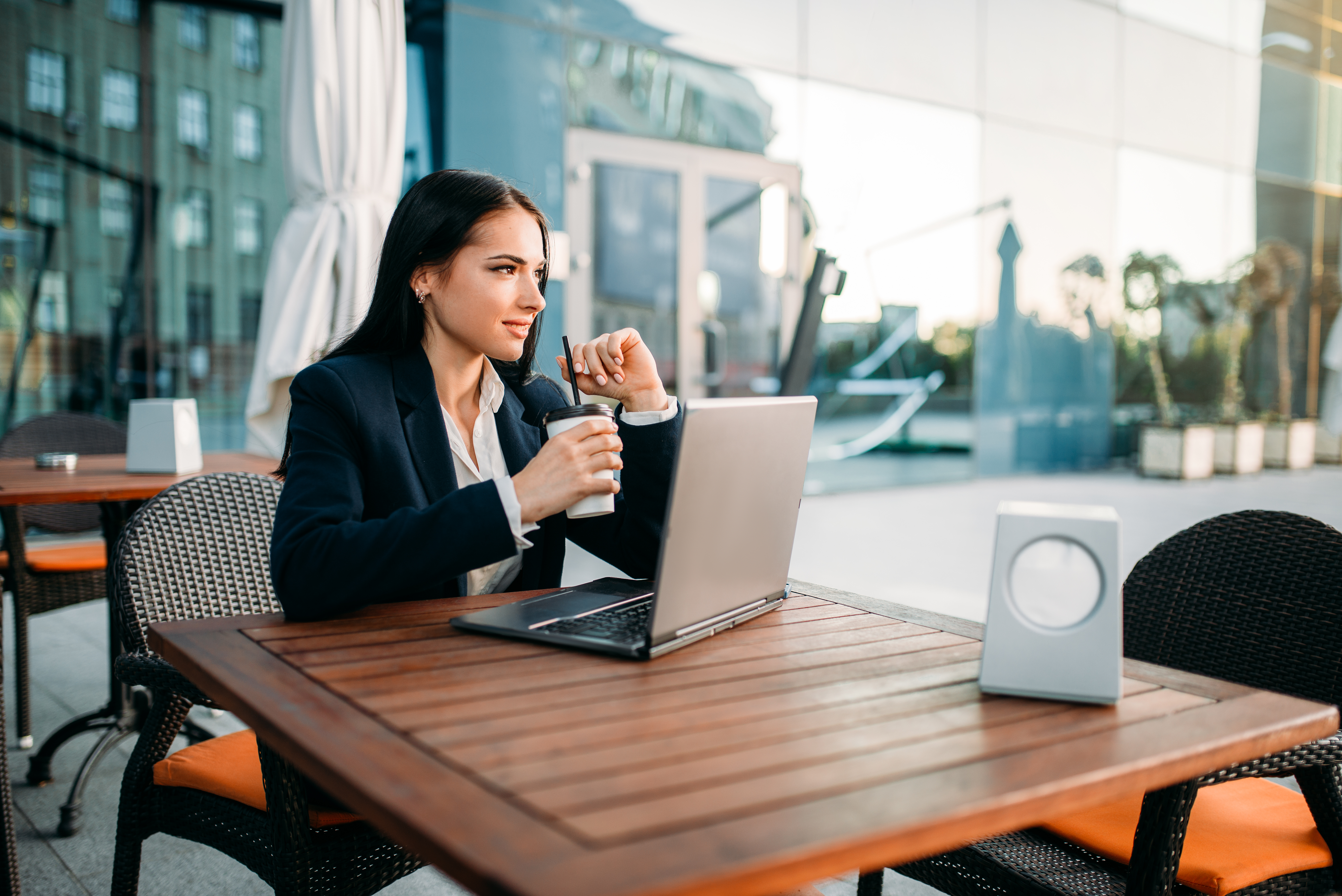 Businesswoman works on laptop in office, top view